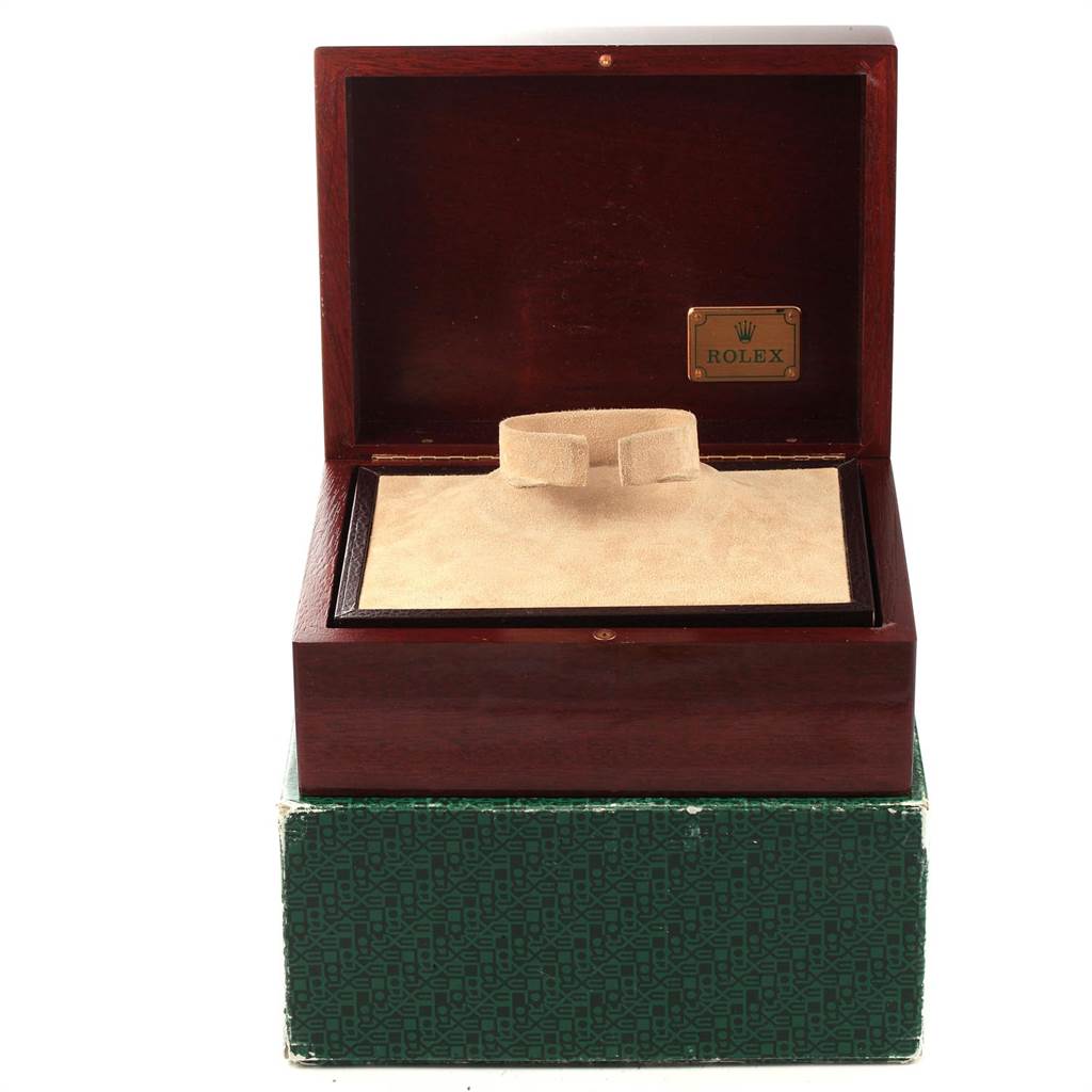 The image shows an open Rolex Daytona 16528 Men's Yellow Gold Black Dial 16528 Men's Yellow Gold Black Dial watch box and cushion, showcasing the brand's emblem inside.