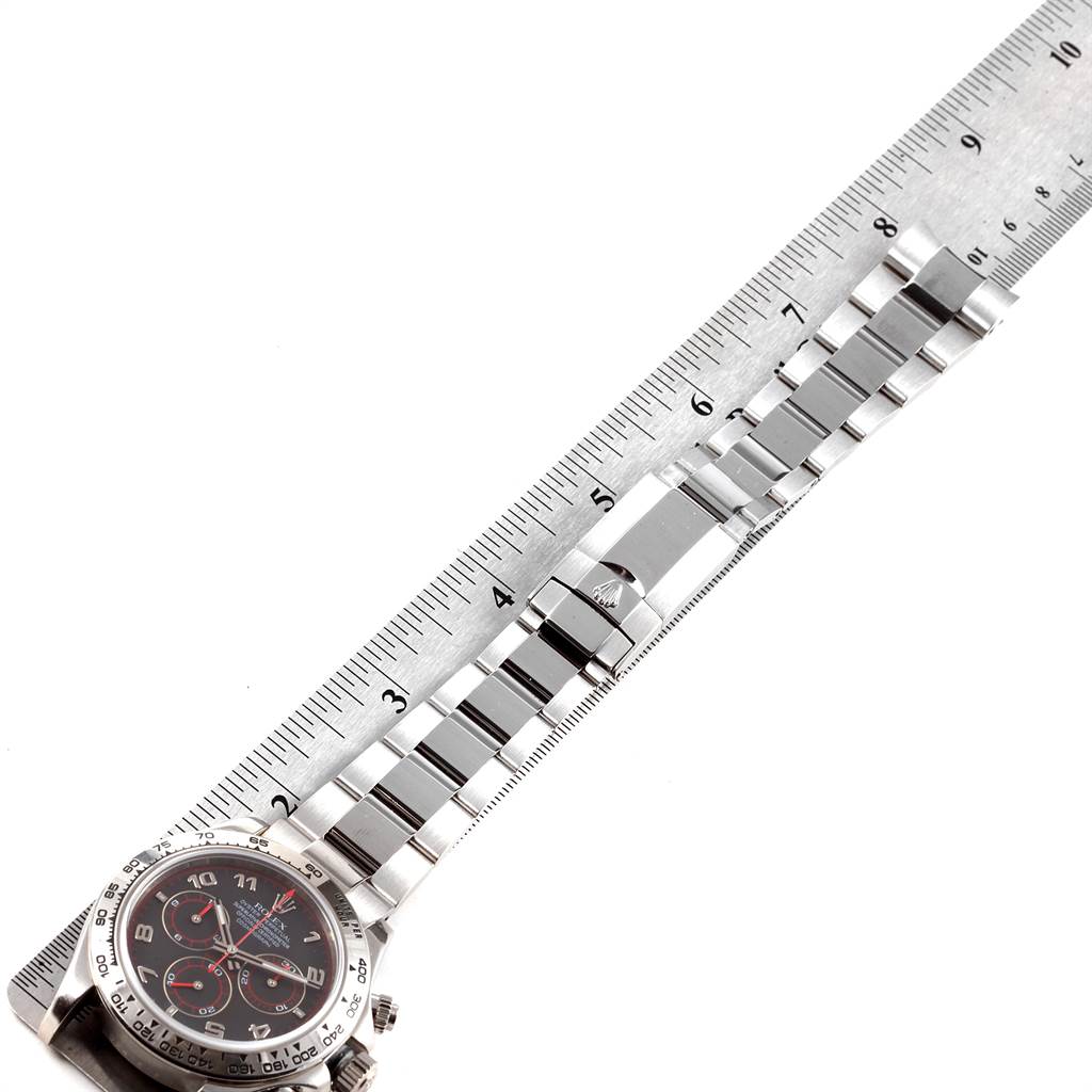 The image shows a Rolex Daytona 116509 Men's White Gold Black Dial 116509 Men's White Gold Black Dial watch laid flat with a ruler alongside its metal bracelet for measurement.