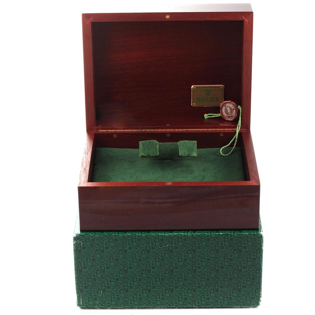 This image shows an open Rolex watch box for the Daytona model, featuring a green interior and a Rolex tag.
