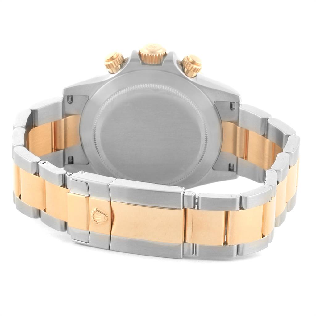 The image shows the back and clasp of a Rolex Daytona 116523 Men's Steel and Gold (two tone) Grey Dial 116523 Men's Steel and Gold (two tone) Grey Dial watch, highlighting its two-tone bracelet and crown.