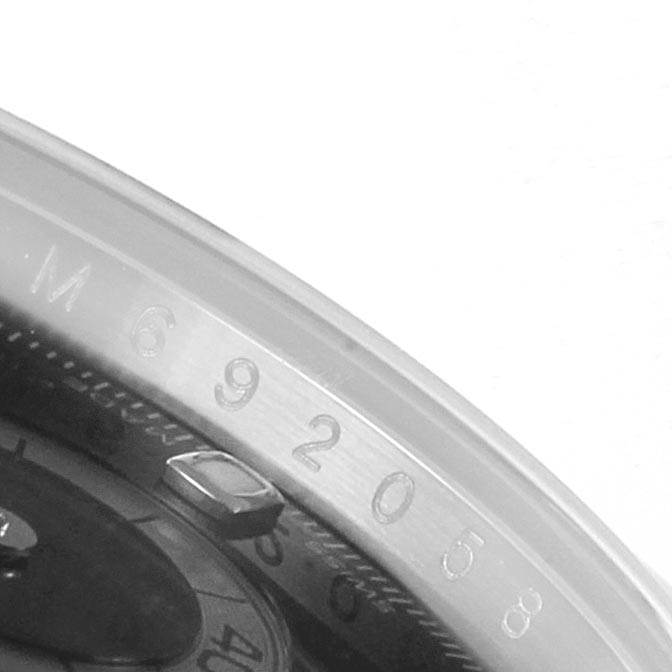 This image shows a close-up, angled view of the outer bezel and part of the dial of a Rolex Daytona 116520 Men's Stainless Steel Black Dial 116520 Men's Stainless Steel Black Dial watch.