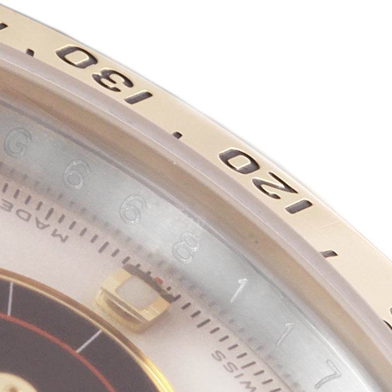 The close-up angle shows the bezel and part of the dial of the Rolex Daytona 116523 Men's Steel and Gold (two tone) White Dial 116523 Men's Steel and Gold (two tone) White Dial watch.