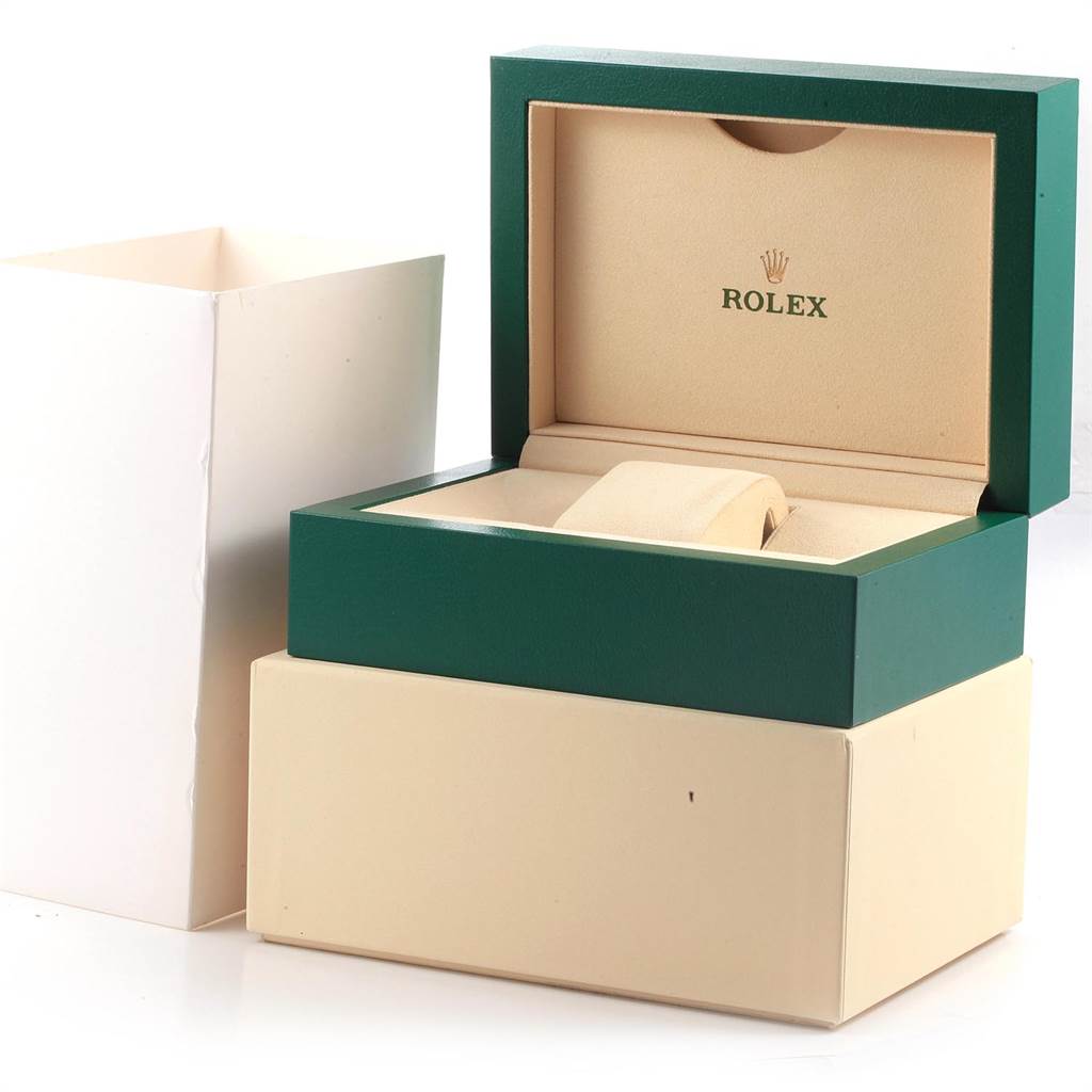 The image shows the opened green and beige Rolex Daytona 116520 Men's Stainless Steel White Dial 116520 Men's Stainless Steel White Dial watch box, placed on a white and beige outer box.