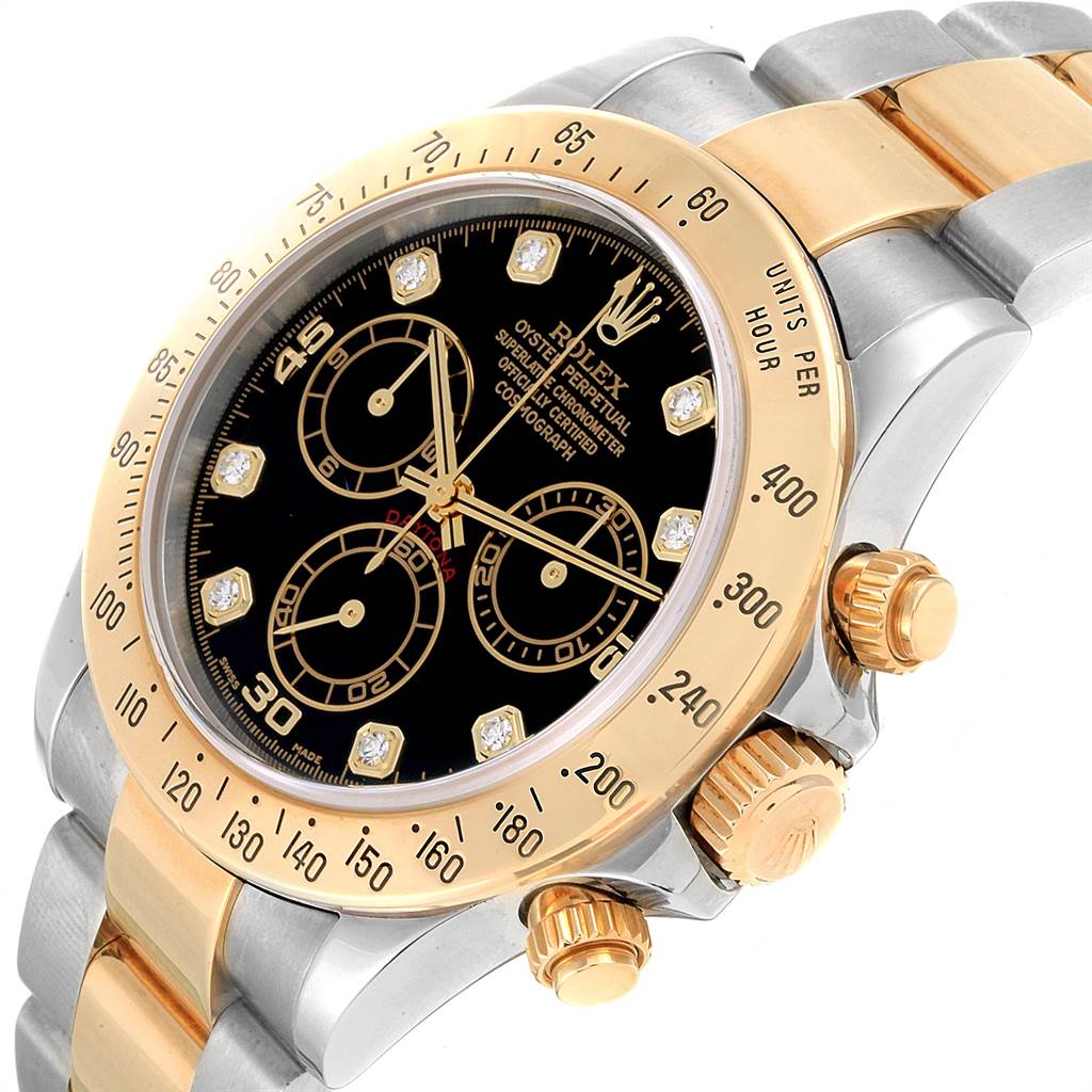 The image shows a close-up angle of a Rolex Daytona 116523 Men
s Steel and Gold (two tone) Black Dial 116523 Men
s Steel and Gold (two tone) Black Dial watch, highlighting the bezel, dial, crown, and chronograph pushers.