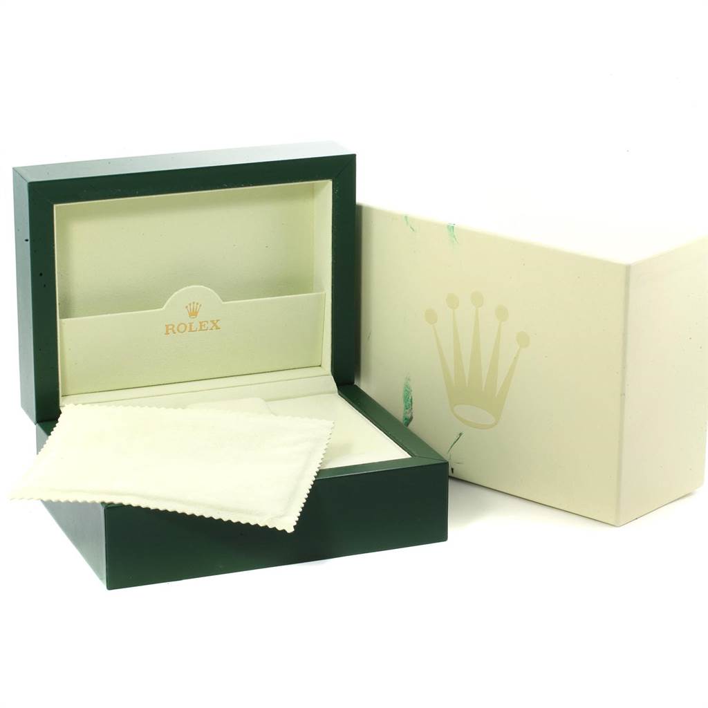 The image shows a Rolex Daytona 116523 Men
s Steel and Gold (two tone) Black Dial 116523 Men
s Steel and Gold (two tone) Black Dial watch box and a cleaning cloth.