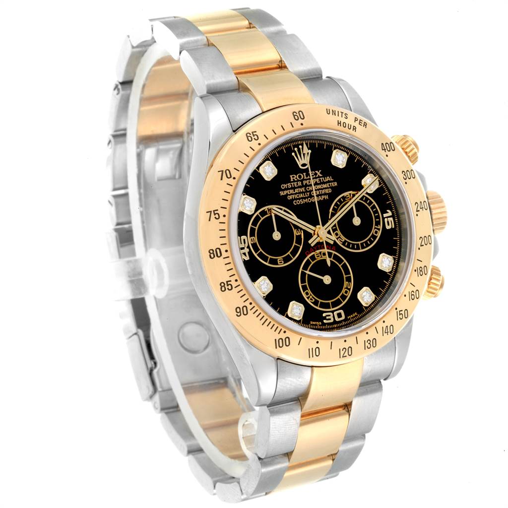 The image shows a Rolex Daytona 116523 Men
s Steel and Gold (two tone) Black Dial 116523 Men
s Steel and Gold (two tone) Black Dial watch at a three-quarter angle, displaying its face, bezel, pushers, and bracelet.
