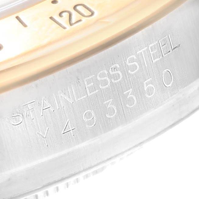 This image shows a close-up view of the case side and bezel of a Rolex Daytona 116523 Men
s Steel and Gold (two tone) Black Dial 116523 Men
s Steel and Gold (two tone) Black Dial watch with the serial number engraved.