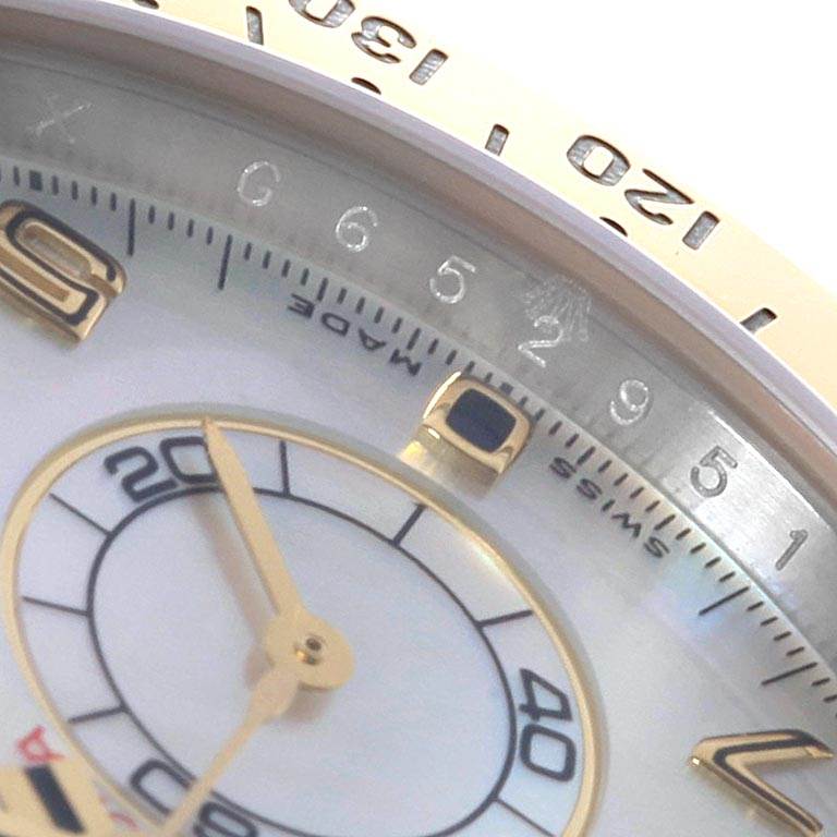 The image shows a close-up of the dial and bezel of the Rolex Daytona 116523 Men's Steel and Gold (two tone) Mother of Pearl Dial 116523 Men's Steel and Gold (two tone) Mother of Pearl Dial watch, highlighting numerals and hands details.