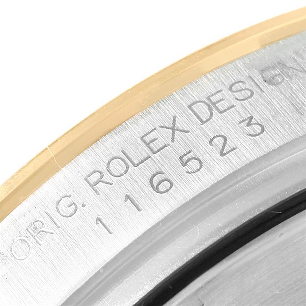 The image shows a close-up of the serial number engraved on the case of a Rolex Daytona 116523 Men's Steel and Gold (two tone) Mother of Pearl Dial 116523 Men's Steel and Gold (two tone) Mother of Pearl Dial watch.