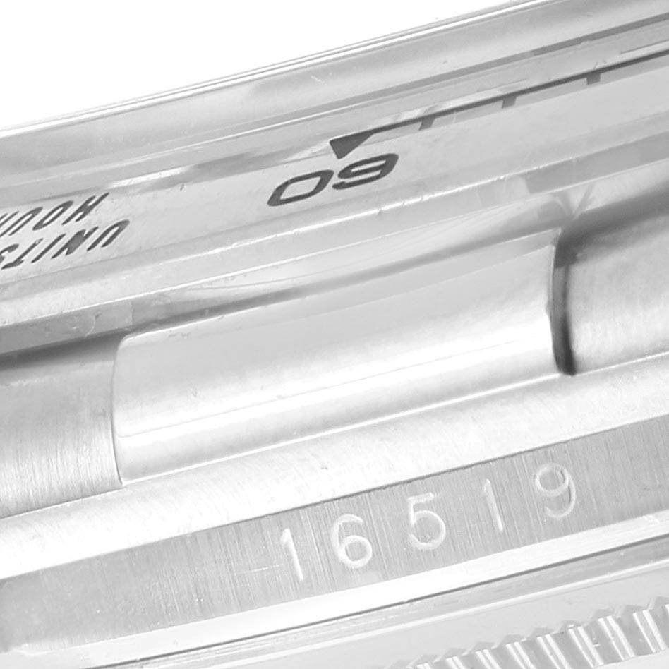 The image shows a close-up angle of the Rolex Daytona 16519 Men
s White Gold White Dial 16519 Men
s White Gold White Dial watch
s case, focusing on the reference number "16519" and part of the bezel.