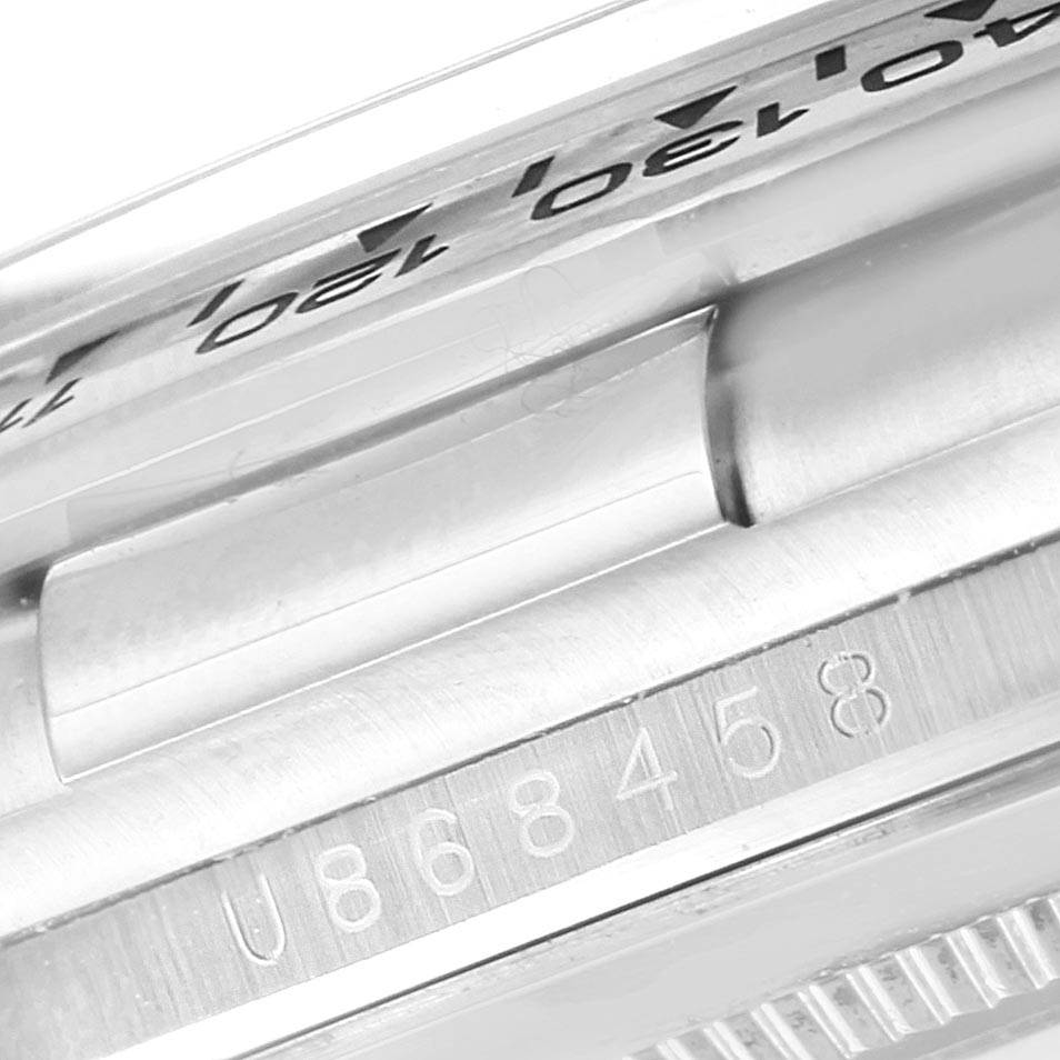 The image shows a close-up of the serial number and a part of the bezel of a Rolex Daytona 16519 Men
s White Gold White Dial 16519 Men
s White Gold White Dial watch.