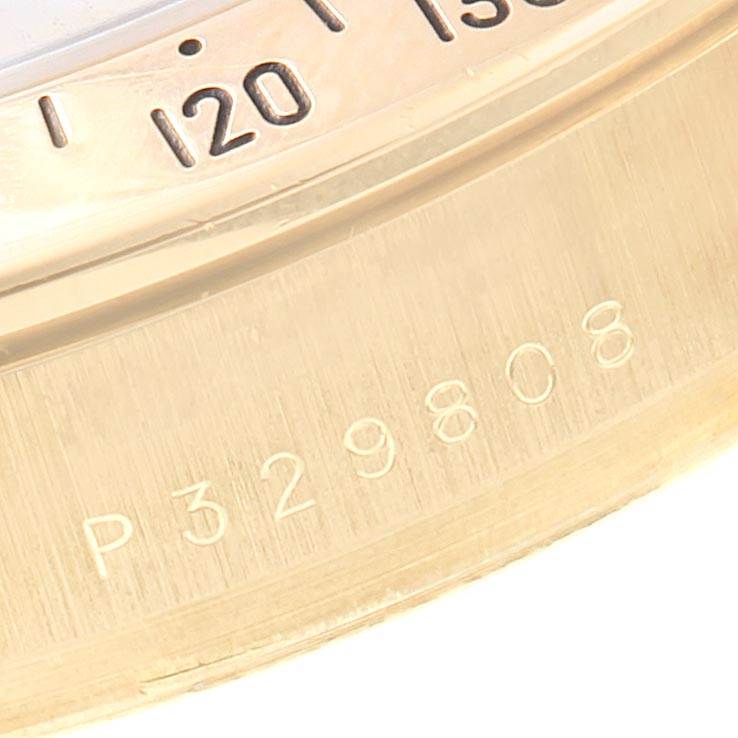 The image shows a close-up of the bezel and engraved serial number of a Rolex Daytona 116528 Men's Yellow Gold Champagne Dial 116528 Men's Yellow Gold Champagne Dial watch.