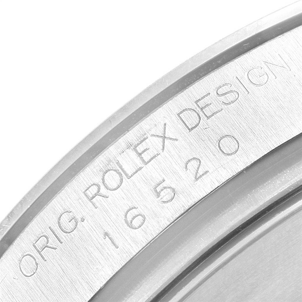 The image shows an up-close view of the serial number engraved on the inner bezel of a Rolex Daytona 16520 Men's Stainless Steel Black Dial 16520 Men's Stainless Steel Black Dial watch.