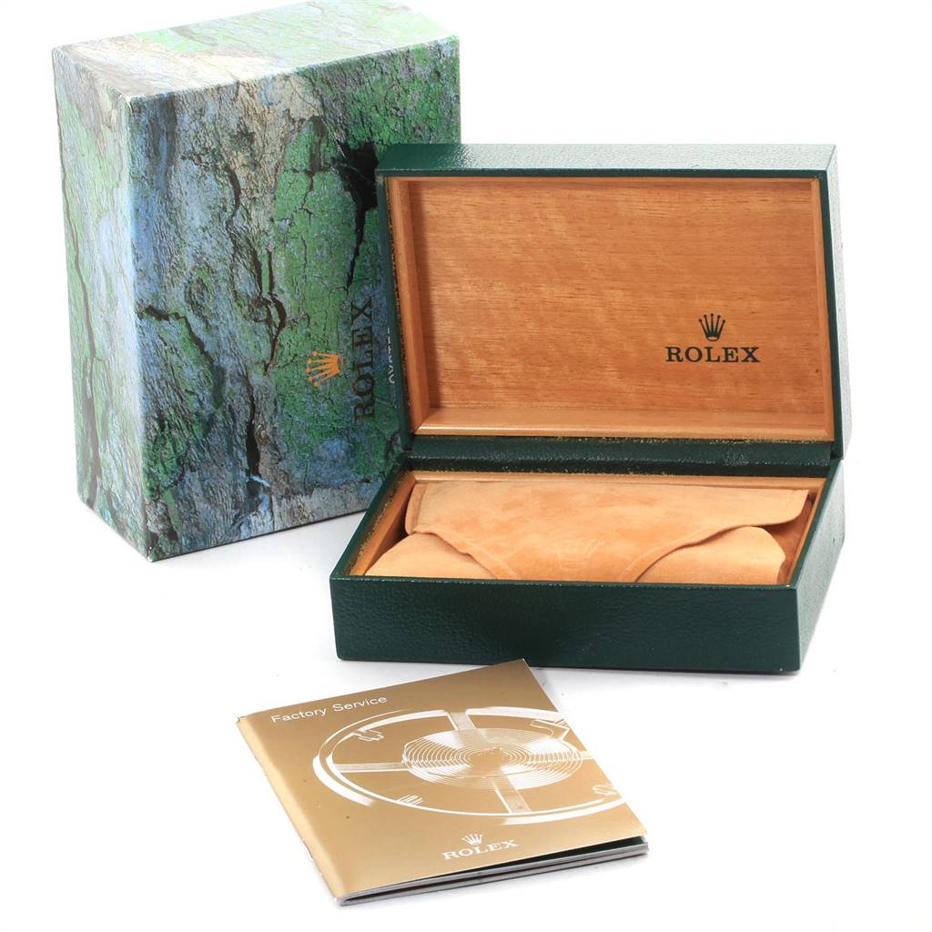 The image shows the packaging and accessories for a Rolex Daytona 16520 Men's Stainless Steel Black Dial 16520 Men's Stainless Steel Black Dial, including a box, outer sleeve, and factory service booklet, angled from the front.