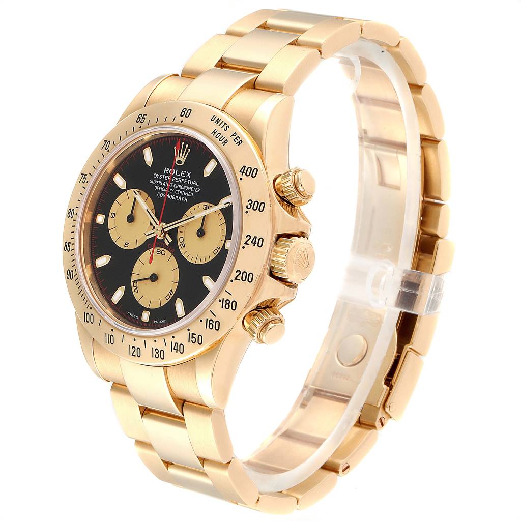 The Rolex Daytona 116528 Men's Yellow Gold Black Dial 116528 Men's Yellow Gold Black Dial watch is shown at a three-quarter angle, displaying the face, bezel, crown, and part of the bracelet.