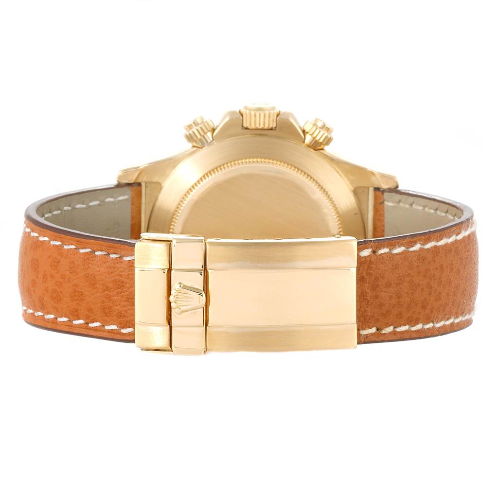 The image shows the back case, crown, and clasp of a Rolex Daytona 16518 Men's Yellow Gold White Dial 16518 Men's Yellow Gold White Dial watch, with a leather strap.