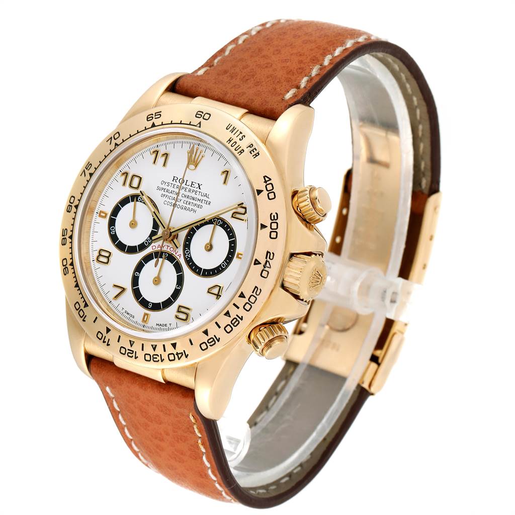 The Rolex Daytona 16518 Men's Yellow Gold White Dial 16518 Men's Yellow Gold White Dial watch is shown at an angle displaying the dial, bezel, crown, pushers, and leather strap.