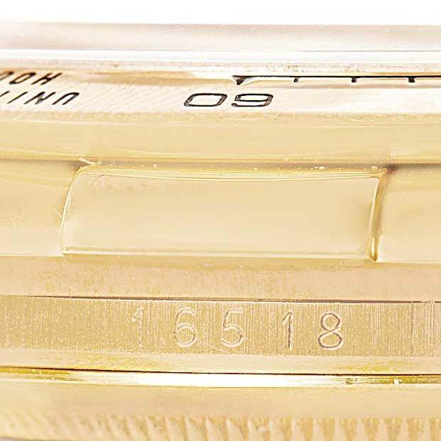 This image shows a close-up of the side of the Rolex Daytona 16518 Men's Yellow Gold White Dial 16518 Men's Yellow Gold White Dial, focusing on its bezel and model number 16518.