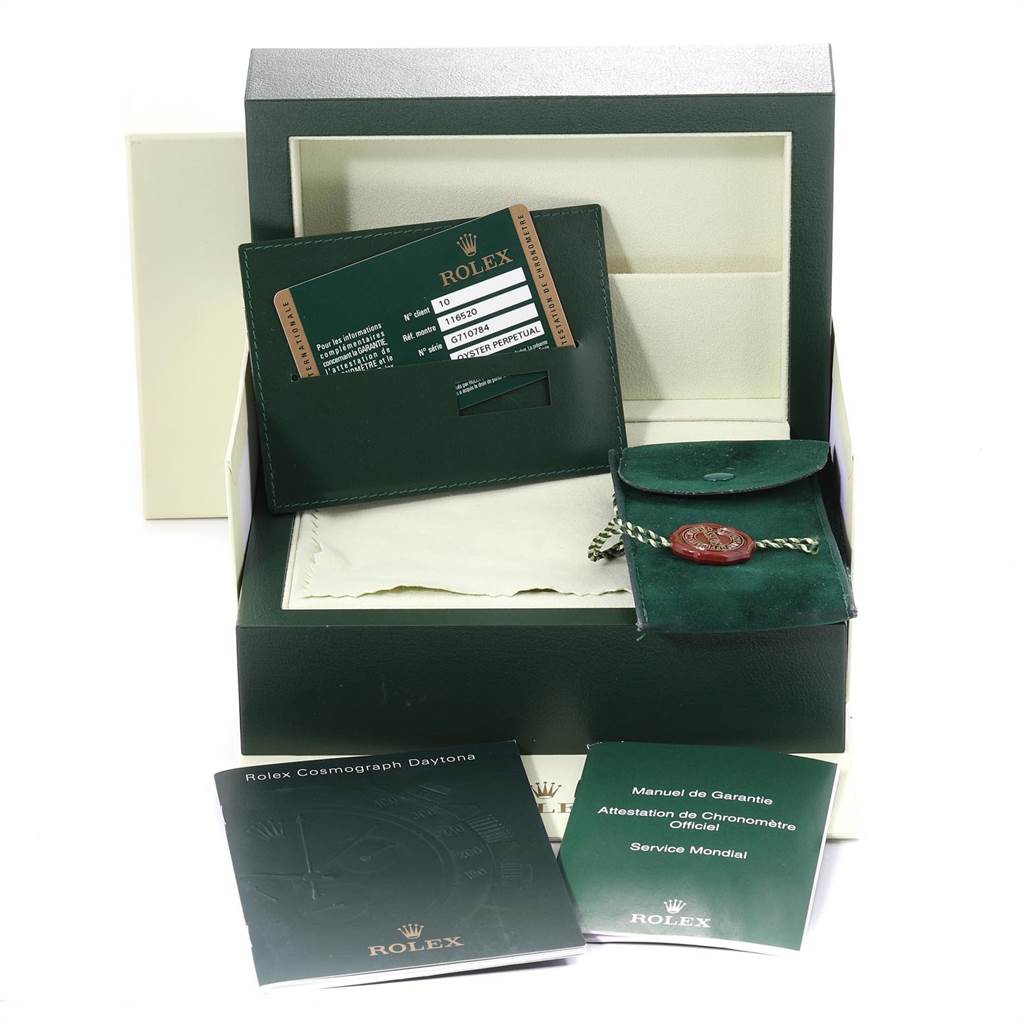 This image shows an unpacked Rolex Daytona 116520 Men's Stainless Steel Black Dial 116520 Men's Stainless Steel Black Dial kit, with the warranty card, manuals, and a pouch accessory.