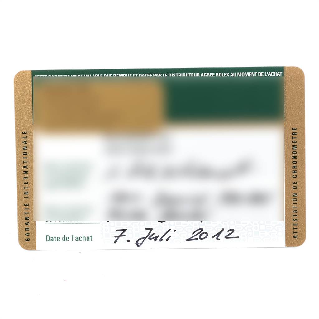 This image shows an angled view of the guarantee card for a Rolex Daytona 116520 Men's Stainless Steel Black Dial 116520 Men's Stainless Steel Black Dial watch, detailing the model's purchase date.