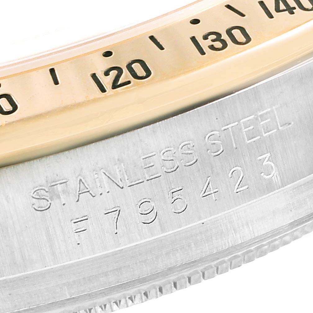 The image shows a close-up of the bezel and case serial number of a Rolex Daytona 116523 Men's Steel and Gold (two tone) Grey Dial 116523 Men's Steel and Gold (two tone) Grey Dial watch.