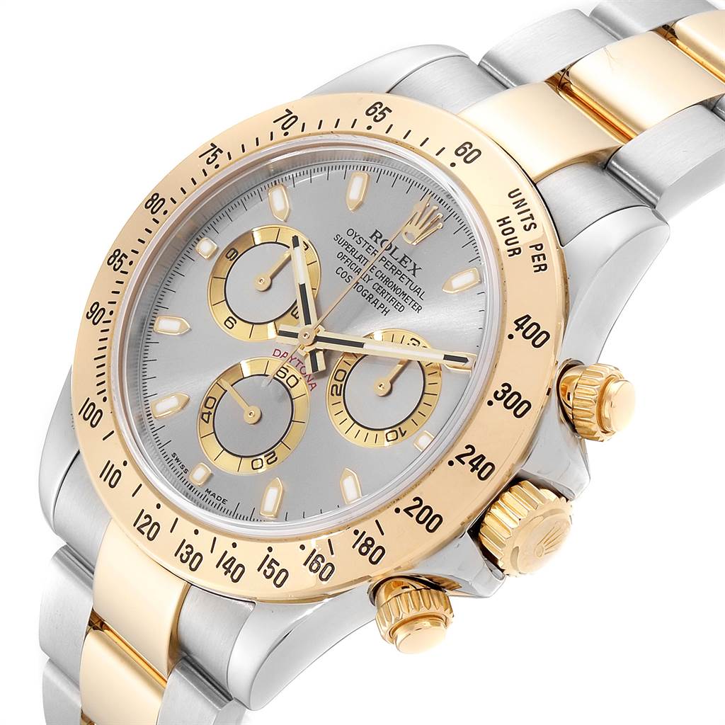 The image shows a close-up angle of a Rolex Daytona 116523 Men's Steel and Gold (two tone) Grey Dial 116523 Men's Steel and Gold (two tone) Grey Dial watch highlighting its face, bezel, pushers, and part of the bracelet.