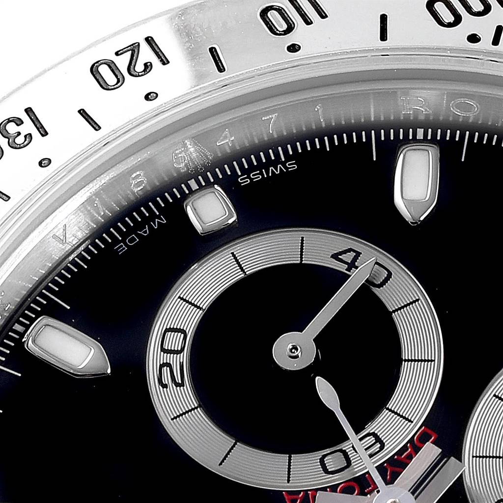 The image shows a close-up of the dial and bezel of a Rolex Daytona 116520 Men's Stainless Steel Black Dial 116520 Men's Stainless Steel Black Dial watch, featuring the sub-dials and part of the tachymeter scale.