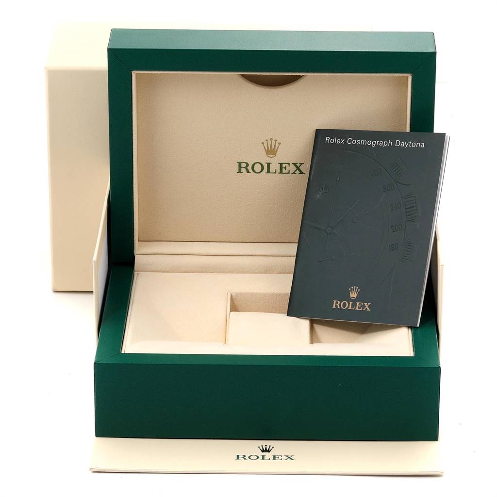This image shows the packaging box and booklet for a Rolex Daytona 116520 Men's Stainless Steel Black Dial 116520 Men's Stainless Steel Black Dial watch, viewed from the front.