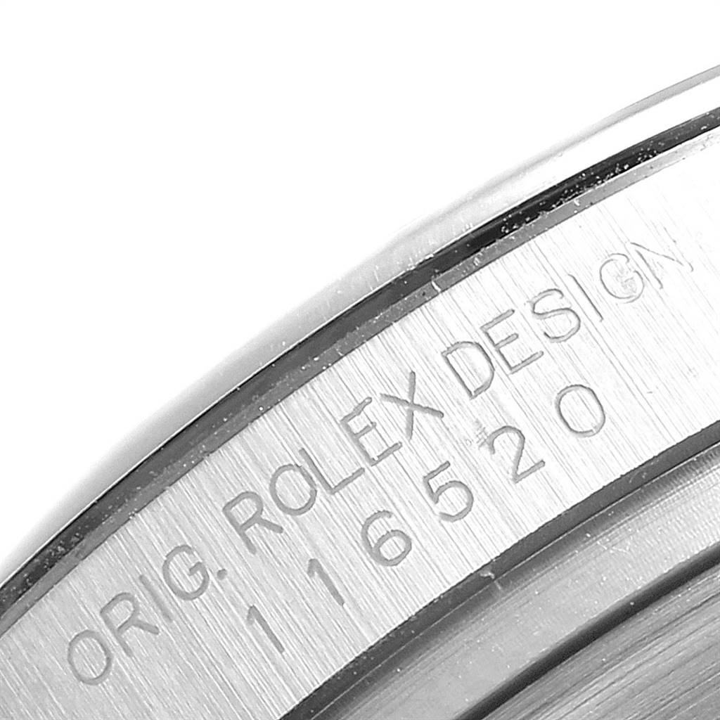 The image shows a close-up of the engraved edge of a Rolex Daytona 116520 Men's Stainless Steel Black Dial 116520 Men's Stainless Steel Black Dial watch, displaying the model number 116520.