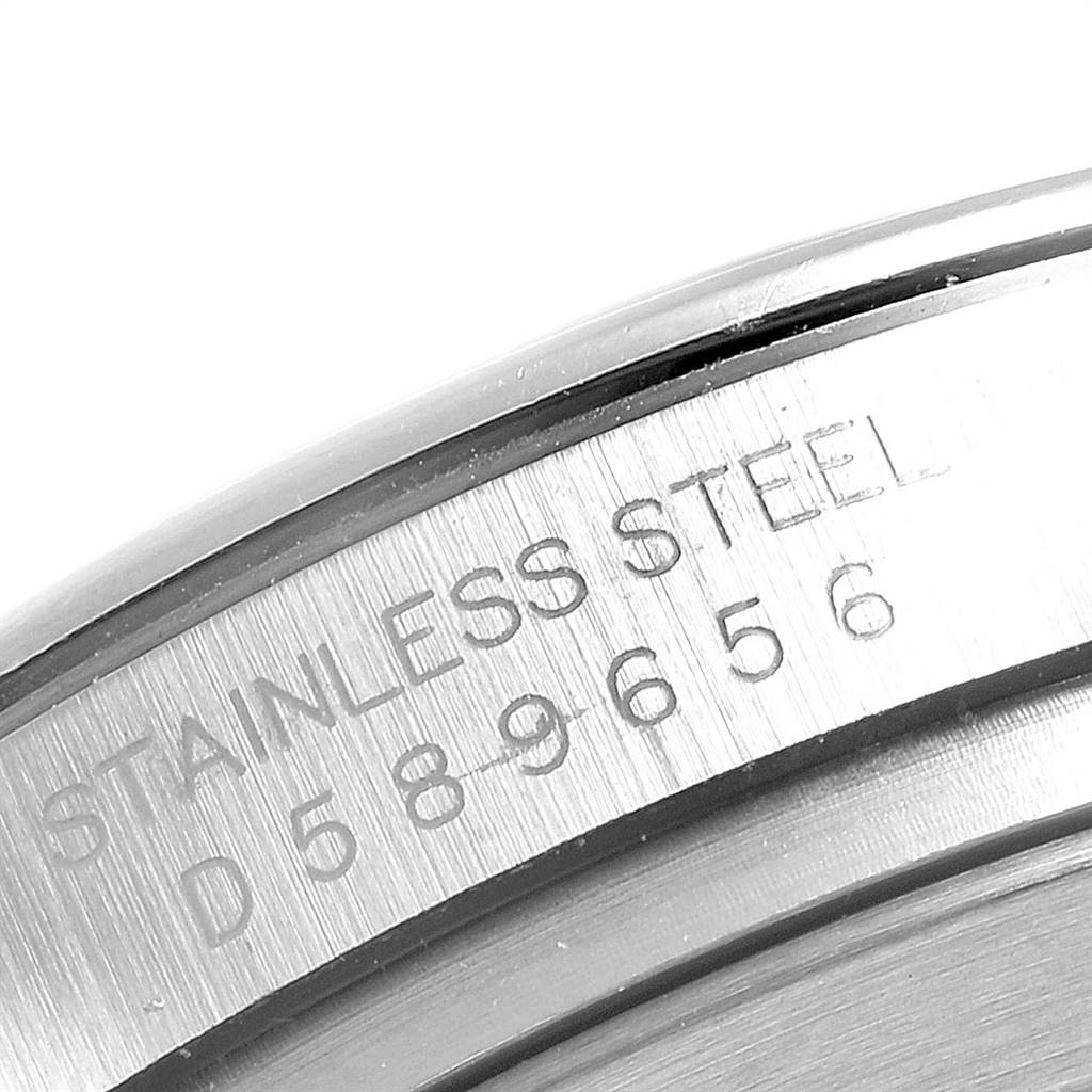 The image shows a close-up of the serial number and "STAINLESS STEEL" engraving on the case back of a Rolex Daytona 116520 Men's Stainless Steel Black Dial 116520 Men's Stainless Steel Black Dial.