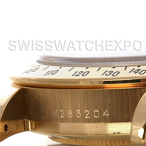 This image shows a side angle close-up of the Rolex Daytona 116528 Men's Yellow Gold Black Dial 116528 Men's Yellow Gold Black Dial watch case, highlighting the bezel and engraved serial number.