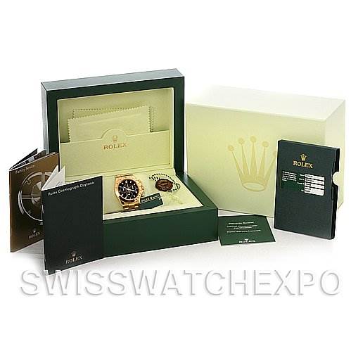 The image shows a Rolex Daytona 116528 Men's Yellow Gold Black Dial 116528 Men's Yellow Gold Black Dial watch and its accessories, including the box, manuals, and warranty card, from a front angle.