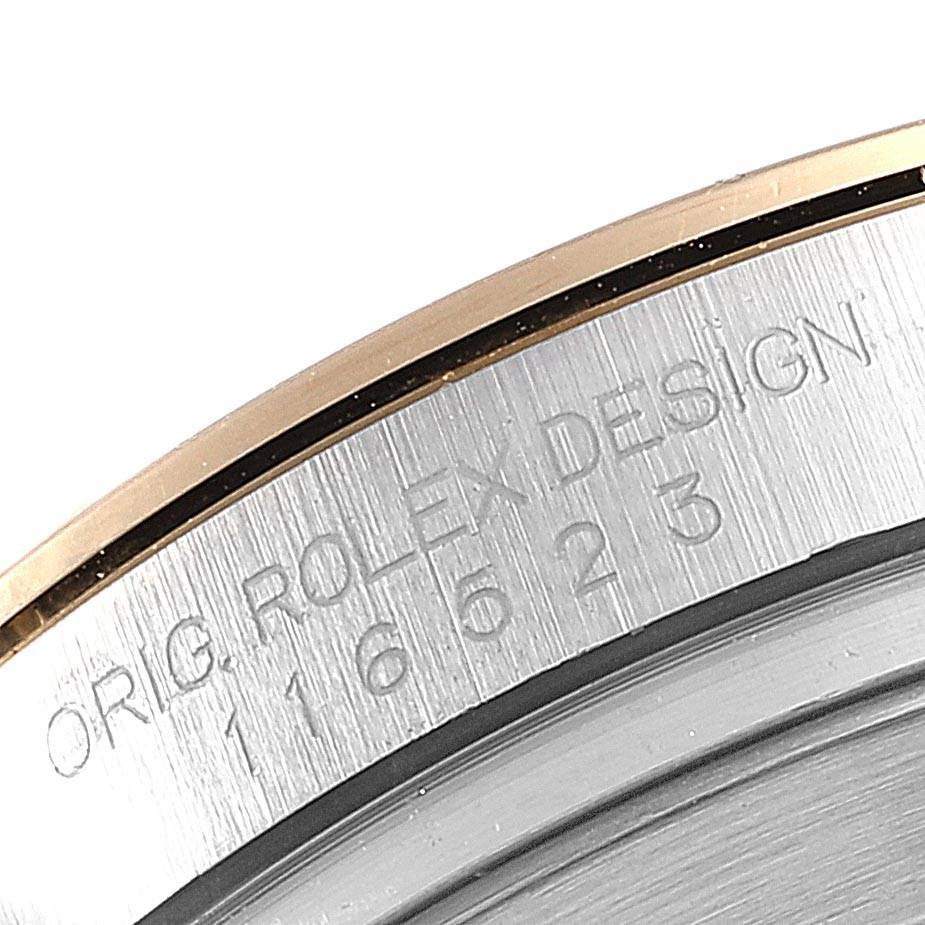 The image shows a close-up of the engraved case back edge of a Rolex Daytona 116523 Men's Steel and Gold (two tone) Blue Dial 116523 Men's Steel and Gold (two tone) Blue Dial watch, highlighting the model number.