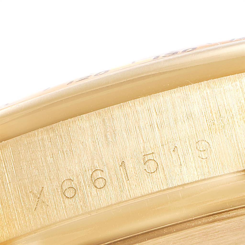 The image shows a close-up of the engraved serial number on the side casing of a Rolex Daytona 16528 Men's Yellow Gold Black Dial 16528 Men's Yellow Gold Black Dial watch.