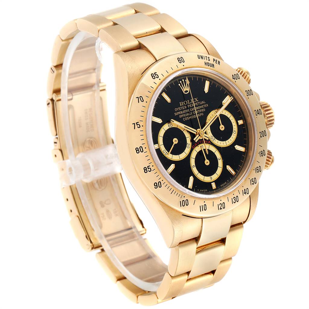 The image shows a Rolex Daytona 16528 Men's Yellow Gold Black Dial 16528 Men's Yellow Gold Black Dial watch from a front-left angle, highlighting its gold case, bracelet, and black dial with three subdials.