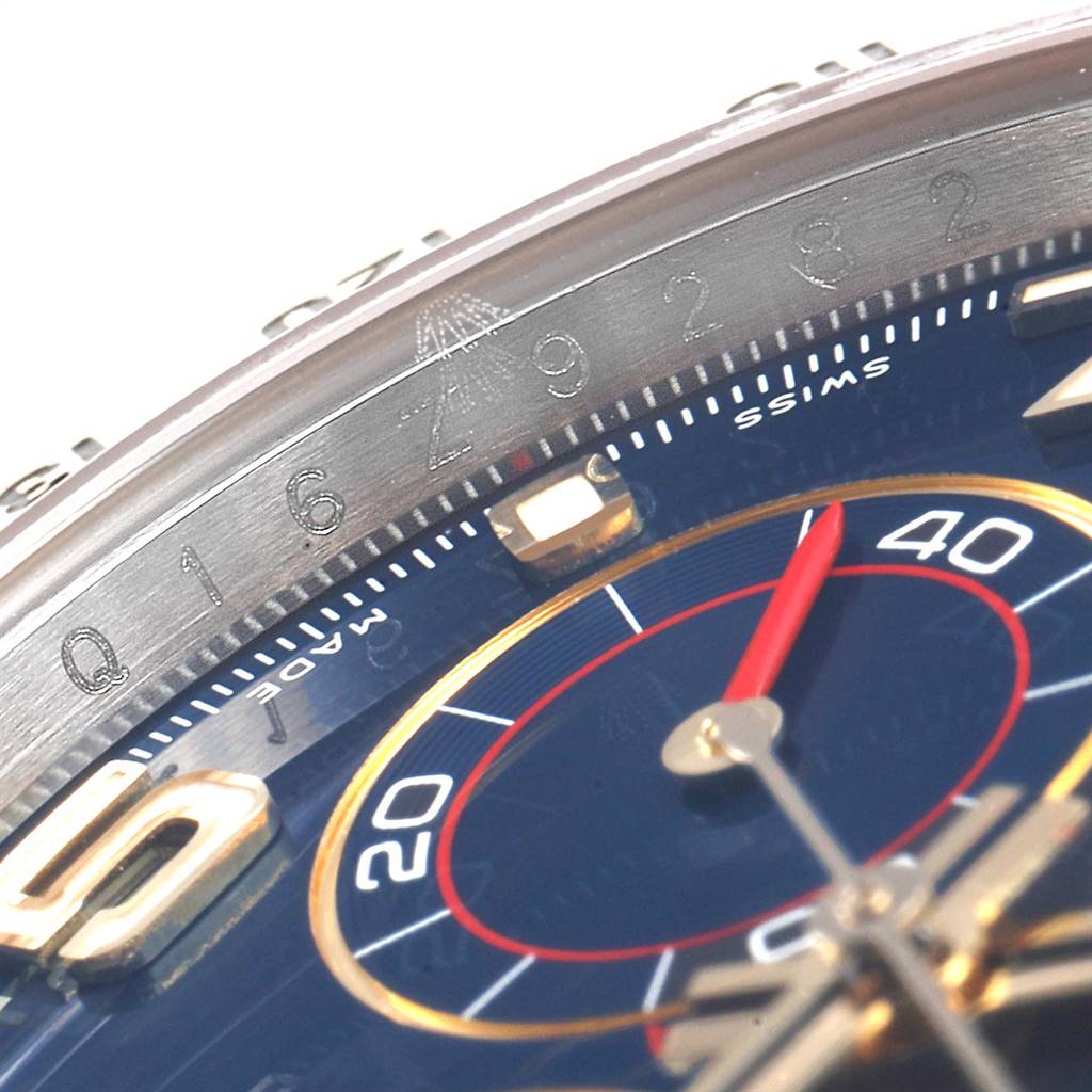 The image shows a close-up of the dial and bezel of a Rolex Daytona 116523 Men's Steel and Gold (two tone) Blue Dial 116523 Men's Steel and Gold (two tone) Blue Dial watch, highlighting the markings and chronograph hand.