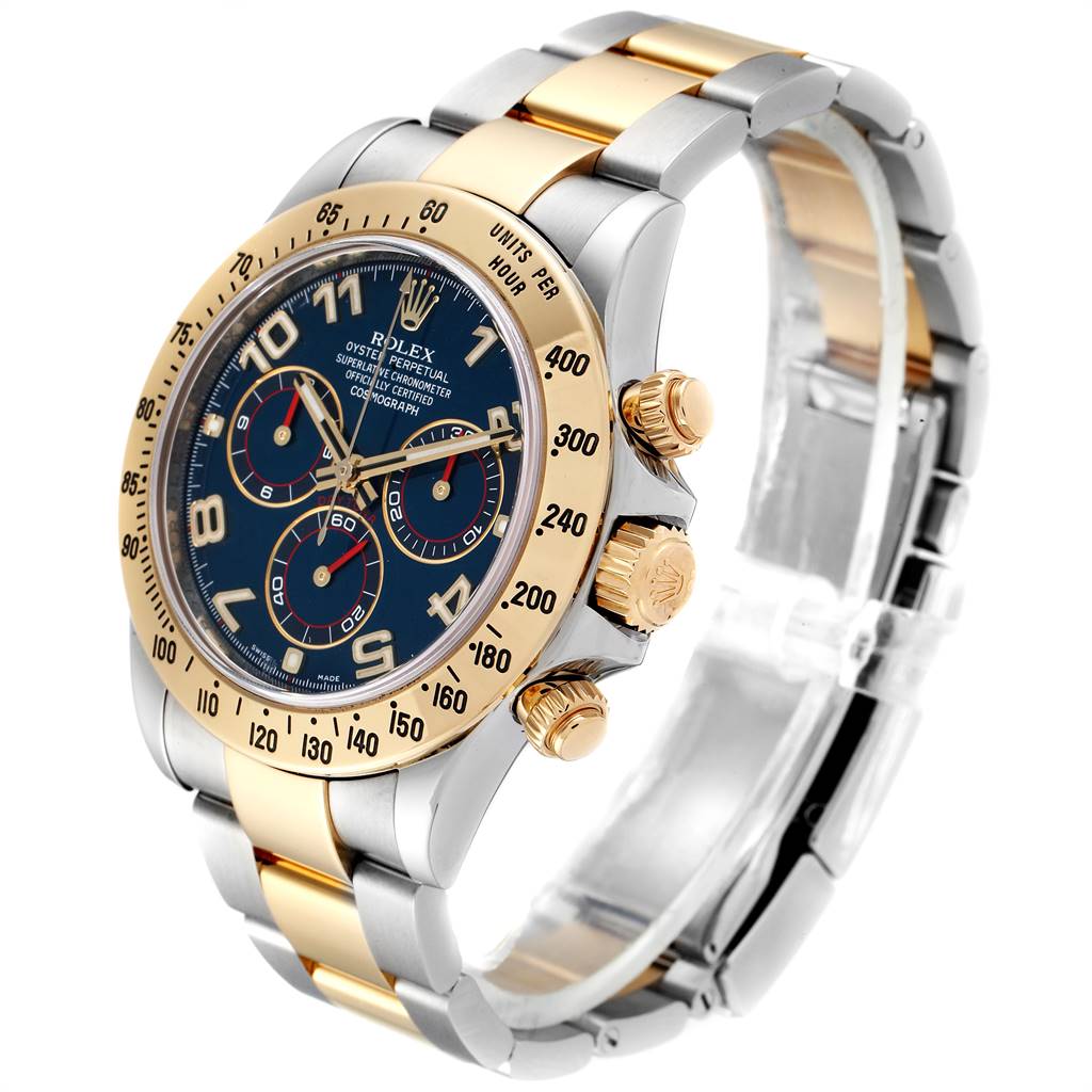 The image shows a Rolex Daytona 116523 Men's Steel and Gold (two tone) Blue Dial 116523 Men's Steel and Gold (two tone) Blue Dial watch at a three-quarter angle, highlighting the gold and steel bracelet, dial, bezel, and pushers.