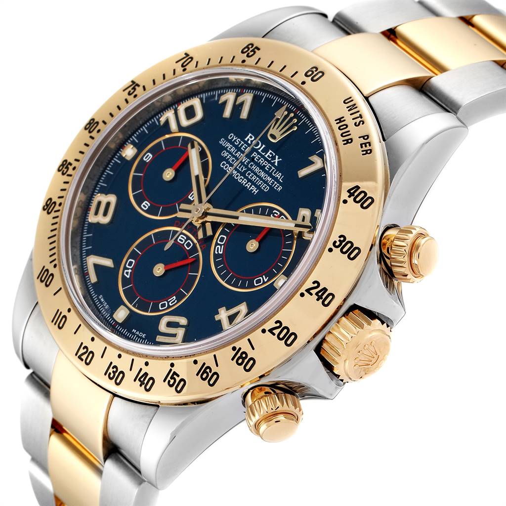 The image shows a close-up of the Rolex Daytona 116523 Men's Steel and Gold (two tone) Blue Dial 116523 Men's Steel and Gold (two tone) Blue Dial watch at an angle highlighting the bezel, dial, and crown.