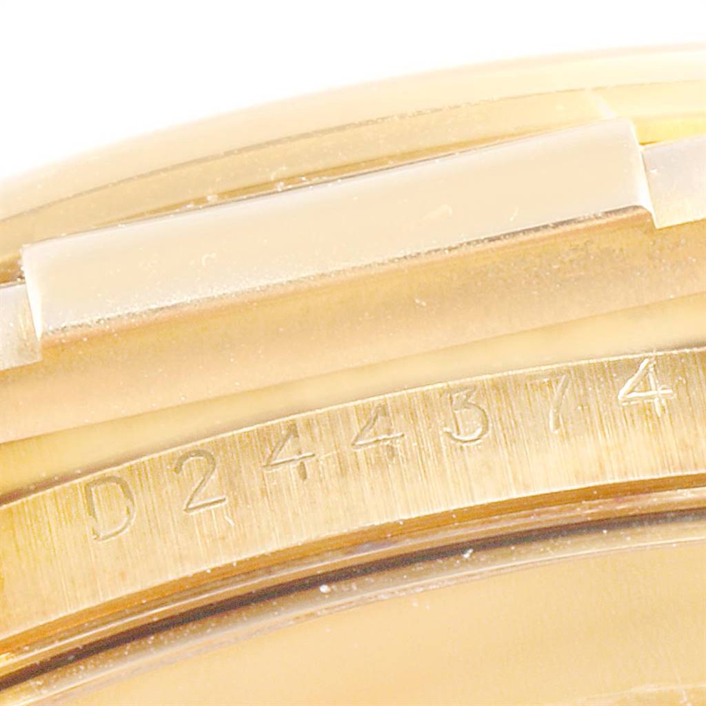 This image shows a close-up of the engraved serial number on the case of a Rolex Daytona 116518 Men's Yellow Gold Champagne Dial 116518 Men's Yellow Gold Champagne Dial watch.