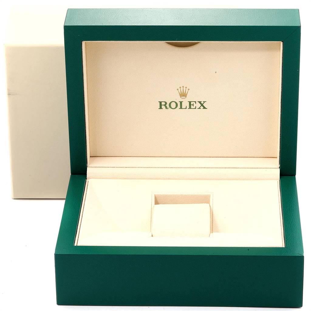 The image shows an empty, open Rolex watch box for the Daytona model, with a green exterior and beige interior.