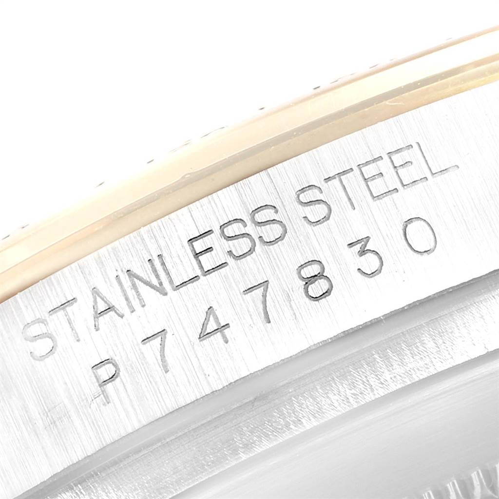 The image shows a close-up of the engraved serial number and "Stainless Steel" mark on the side of a Rolex Daytona 116523 Men's Steel and Gold (two tone) White Dial 116523 Men's Steel and Gold (two tone) White Dial watch.