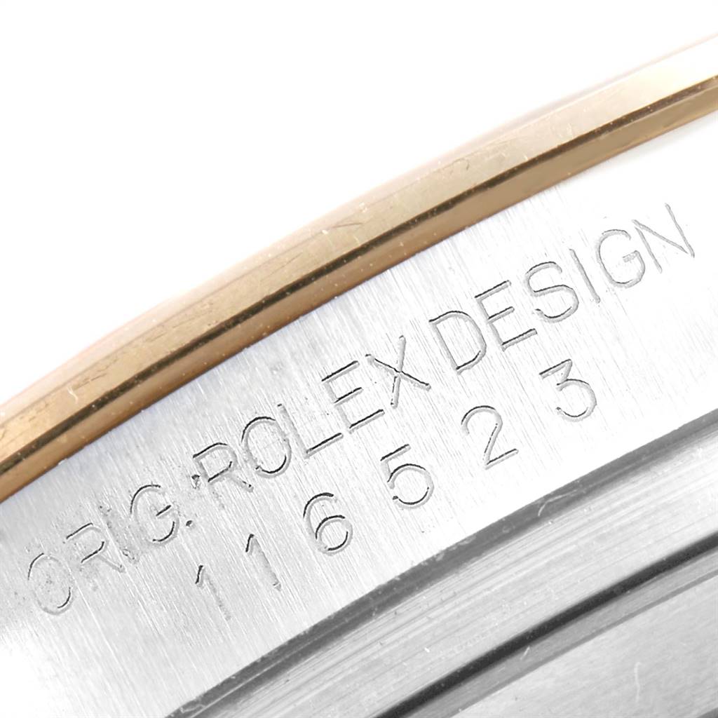 The image shows a close-up, angled view of the bezel and case side of a Rolex Daytona 116523 Men's Steel and Gold (two tone) White Dial 116523 Men's Steel and Gold (two tone) White Dial watch, with the model number engraved.