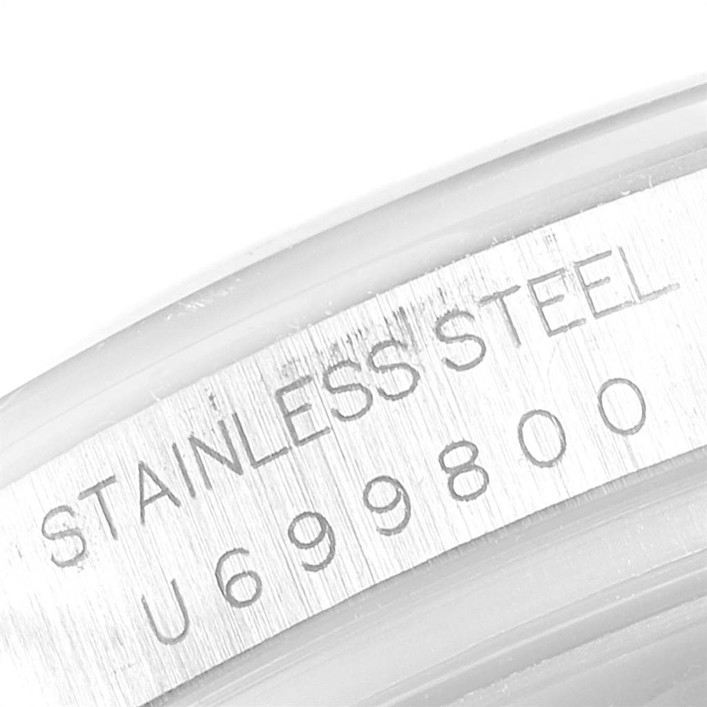 This close-up image shows the "STAINLESS STEEL" and a serial number on the casing of a Rolex Daytona 16520 Men's Stainless Steel White Dial 16520 Men's Stainless Steel White Dial watch.