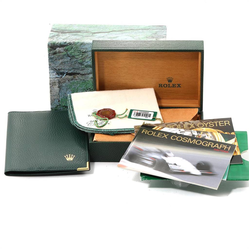 The image shows the packaging and accessories for a Rolex Daytona 16520 Men's Stainless Steel White Dial 16520 Men's Stainless Steel White Dial watch, including the box, manuals, wallet, and tags.