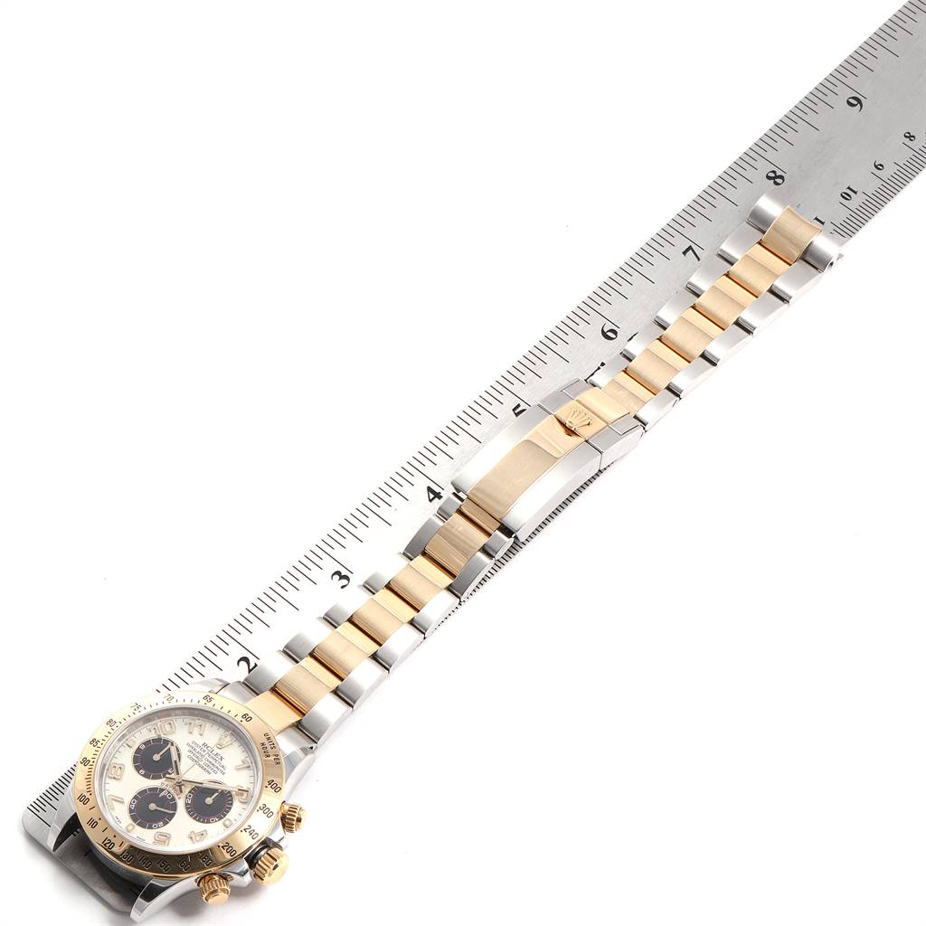 The image shows a Rolex Daytona 116523 Men's Steel and Gold (two tone) Silver Dial 116523 Men's Steel and Gold (two tone) Silver Dial watch lying flat, measured against a ruler, displaying its face and two-tone bracelet.