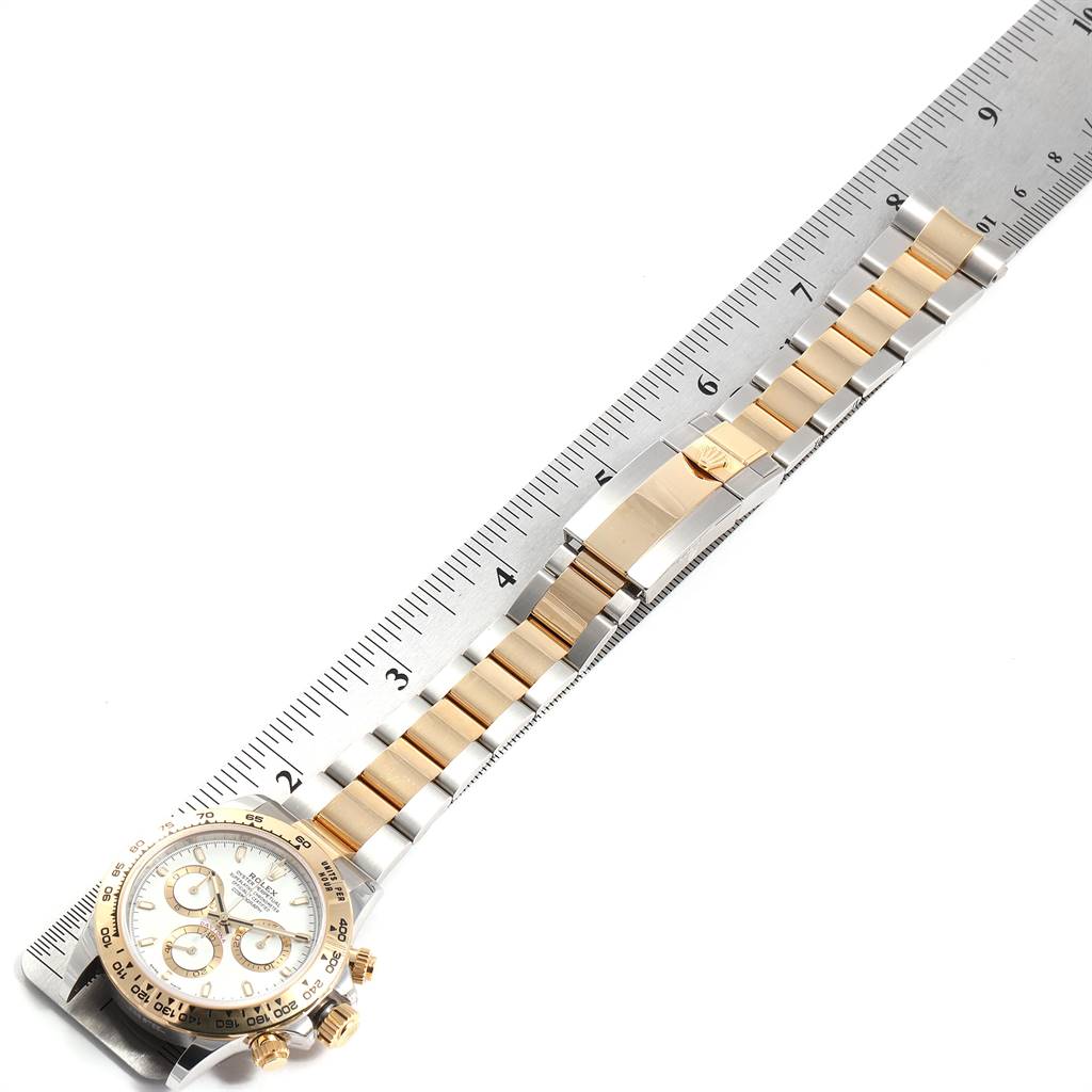 The image shows a Rolex Daytona 116503 Men's Steel and Gold (two tone) White Dial 116503 Men's Steel and Gold (two tone) White Dial watch pictured from an overhead angle with its band aligned along a ruler for measurement.
