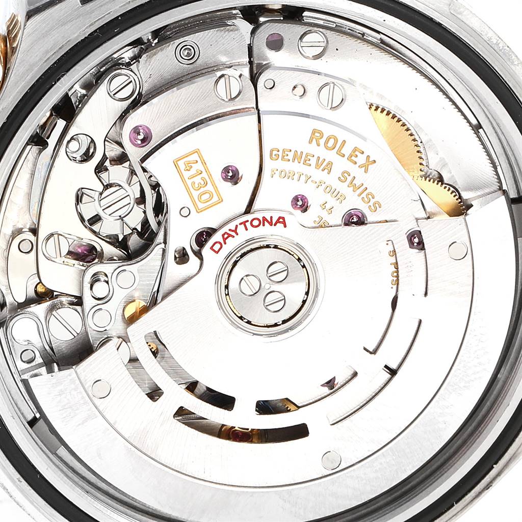 Close-up of the movement and internal mechanics of the Rolex Daytona 116523 Men
s Steel and Gold (two tone) Black Dial 116523 Men
s Steel and Gold (two tone) Black Dial watch, showing gears, rotors, and engravings.