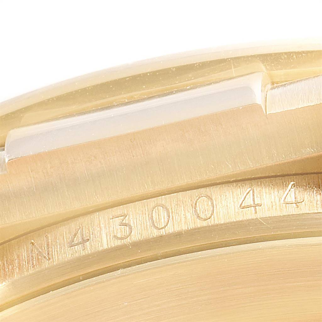 This close-up image shows the serial number engraving on the case of a Rolex Daytona 16518 Men's Yellow Gold White Dial 16518 Men's Yellow Gold White Dial watch.