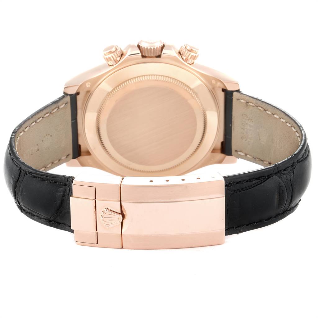 The image shows the back view of a Rolex Daytona 116515LN Men's Rose Gold Brown Dial 116515LN Men's Rose Gold Brown Dial watch focusing on the case, crown, and leather strap with buckle.