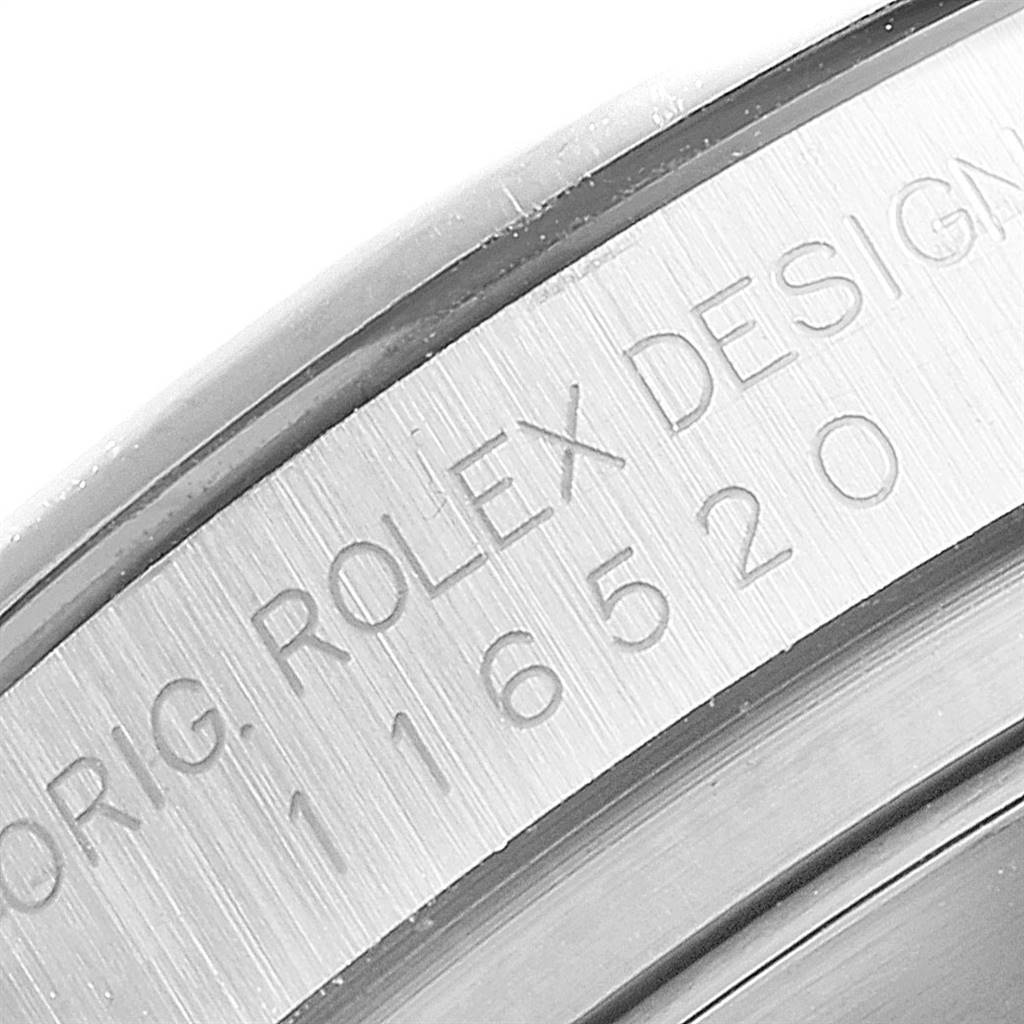 The image shows a close-up of the engraved bezel on a Rolex Daytona 116520 Men's Stainless Steel White Dial 116520 Men's Stainless Steel White Dial watch.